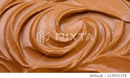 Creamy chocolate spread with smooth, swirled texture, perfect for desserts and snacks. Indulge in its rich flavor and velvety consistency 123651158