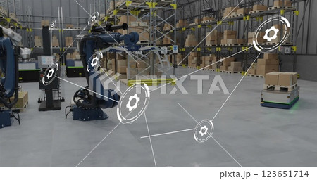 Image of network of connections with icons over machines working in warehouse 123651714
