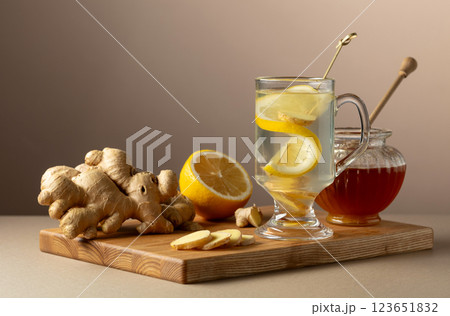 Ginger tea with lemon and honey on a beige background. Ginger tea with lemon and honey on a beige background. 123651832