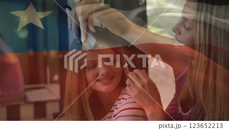 Image of flag of chile over caucasian mother and daughter brushing hair 123652213