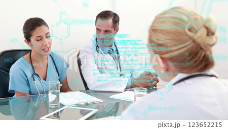 Image of data processing over diverse doctors talking at meeting 123652215