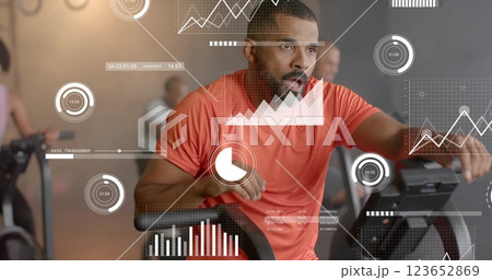 Image of diagrams over diverse sportsmen exercising on elliptical bikes at gym Image of diagrams over diverse sportsmen exercising on elliptical bikes at gym 123652869