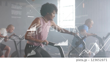 Image of diagrams and data processing over diverse sportspeople using elliptical bikes at gym 123652871