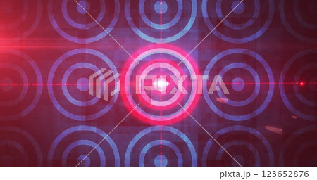 Image of light trails over circles on black background 123652876