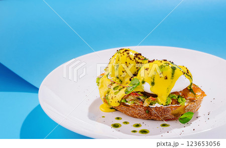Colorful brunch dish featuring poached eggs on toasted bread 123653056