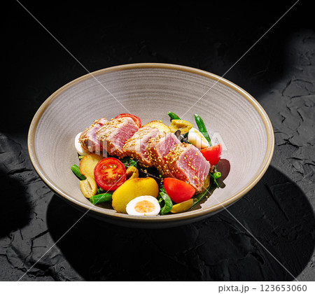 Delicious seared tuna salad served in a modern bowl Delicious seared tuna salad served in a modern bowl 123653060