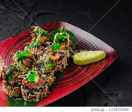 Delicious sushi rolls served on a vibrant plate with wasabi 123653080