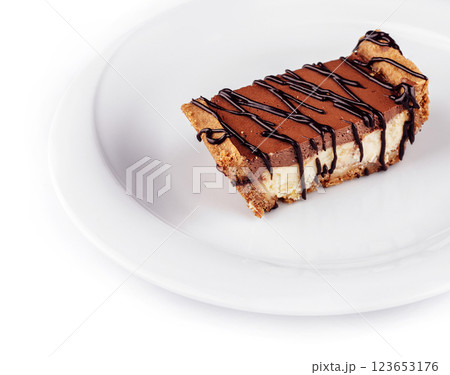 Chocolate cake being placed on white plate Chocolate cake being placed on white plate 123653176