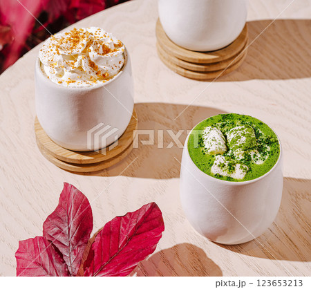 Delightful dessert beverages on wooden table with colorful leaves 123653213