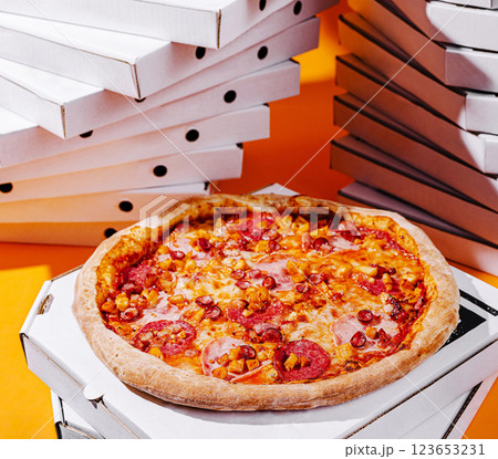 Delicious pizza on a bright orange background with pizza boxes Delicious pizza on a bright orange background with pizza boxes 123653231