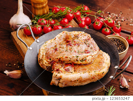 Juicy meat marinated with spices and herbs on a rustic table 123653247