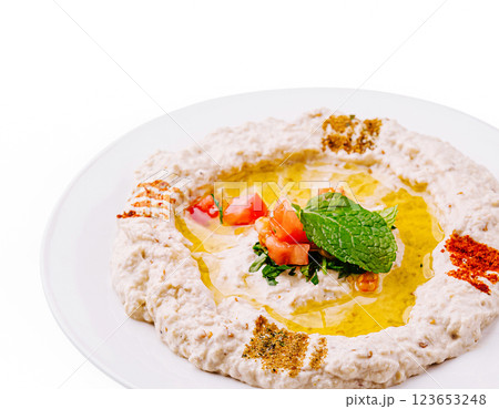 Delicious hummus topped with fresh ingredients and olive oil Delicious hummus topped with fresh ingredients and olive oil 123653248