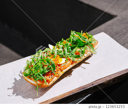 Freshly made sandwich topped with vegetables and herbs served outdoors 123653253