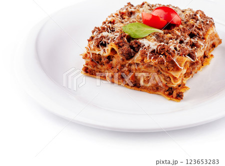 Portion of lasagna sitting on a white plate 123653283