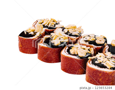 Sweet sushi rolls with chocolate topping and peanuts lying on white background 123653284