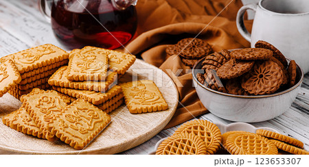 Delicious assortment of cookies served with tea on a wooden table Delicious assortment of cookies served with tea on a wooden table 123653307