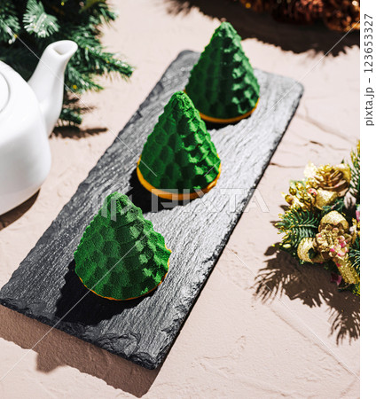 Festive green dessert trio shaped like trees displayed for celebration 123653327