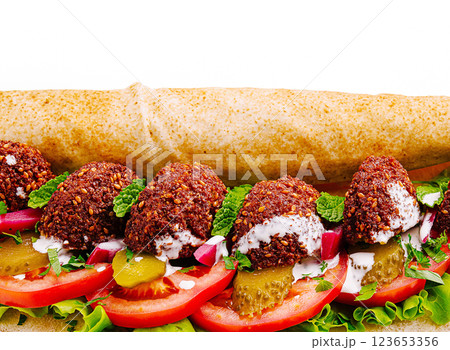 Savory falafel wrap filled with fresh vegetables and sauce Savory falafel wrap filled with fresh vegetables and sauce 123653356