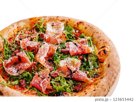 Delicious pizza topped with fresh ingredients and prosciutto Delicious pizza topped with fresh ingredients and prosciutto 123653442