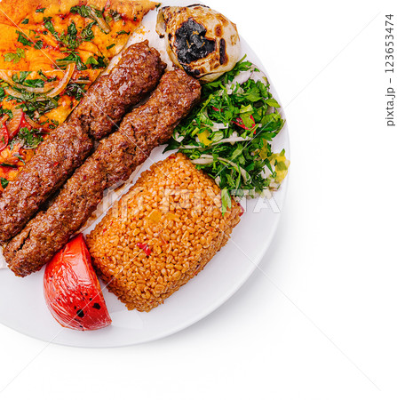 Delicious gourmet kebab platter with fresh sides and rice Delicious gourmet kebab platter with fresh sides and rice 123653474