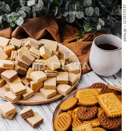 Delicious assortment of cookies and wafers on a rustic table Delicious assortment of cookies and wafers on a rustic table 123653537
