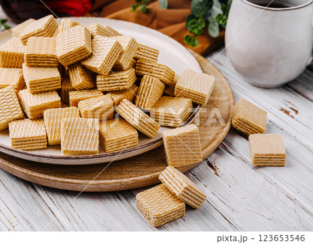 Sweet crunchy wafers served on a rustic wooden table Sweet crunchy wafers served on a rustic wooden table 123653546
