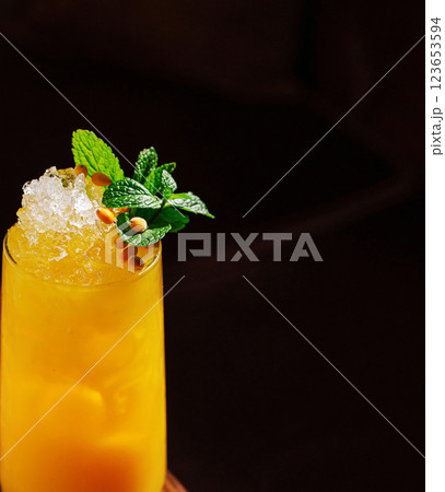 Refreshing tropical cocktail topped with mint and pine nuts 123653594