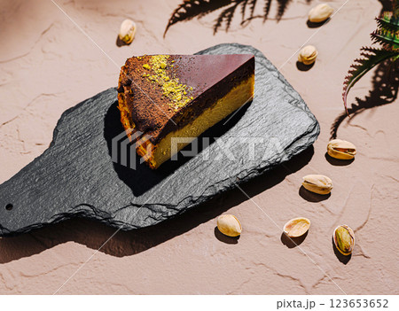 Delicious slice of layered cake served on a slate platter 123653652