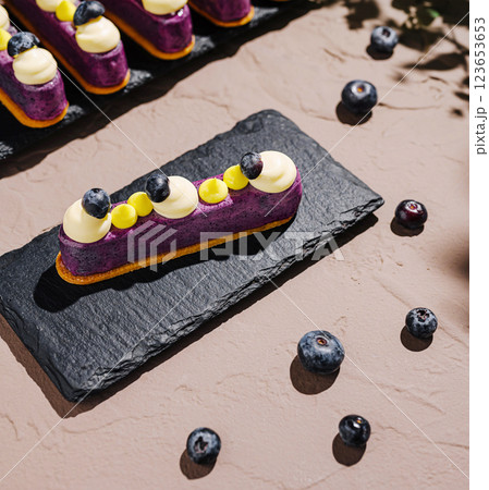 Delightful dessert display featuring blueberry tart on slate Delightful dessert display featuring blueberry tart on slate 123653653
