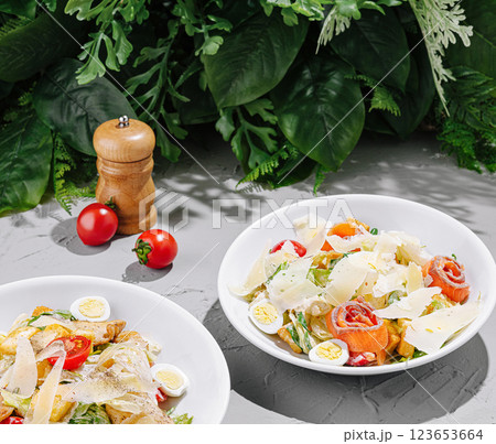 Fresh salads with cherry tomatoes and parmesan on a table 123653664