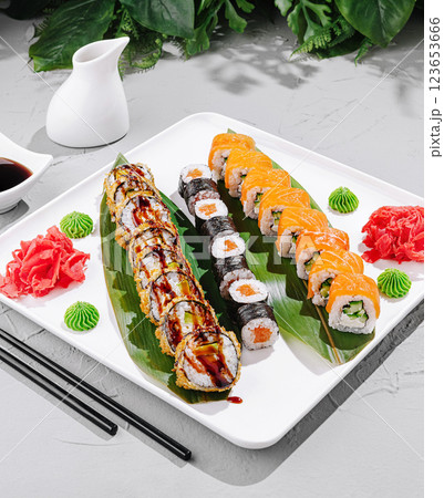 Colorful sushi platter with garnishes and sauces on a serving tray 123653666