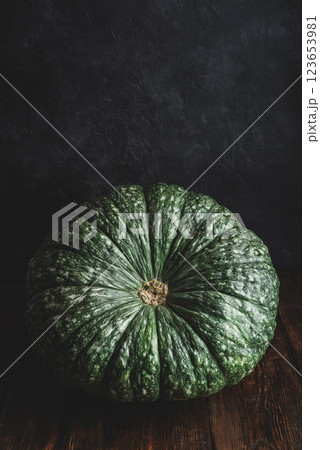Giant green pumpkin on wooden surface Giant green pumpkin on wooden surface 123653981