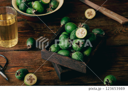 Small tray full of feijoa fruits on wooden background Small tray full of feijoa fruits on wooden background 123653989