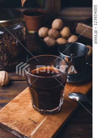 Glass of coffee brewed in traditional vietnamese drip filter 123654005