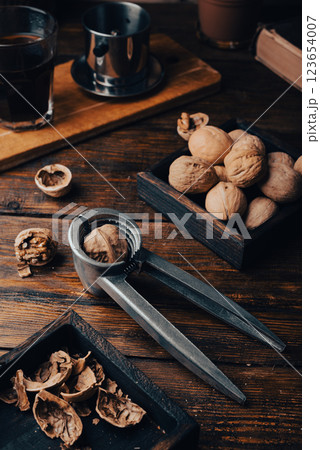 Walnuts and nutcracker on table 123654007