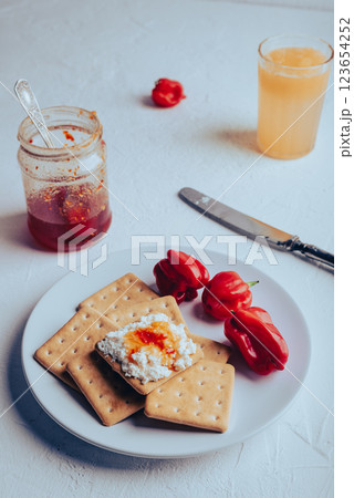 Snack with crackers, ricotta cheese and hot pepper jelly 123654252
