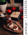 Light snack with crackers, sun-dried tomatoes and cream cheese 123654256