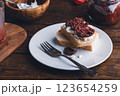 Toast with cream cheese and sundried tomatoes on plate 123654259