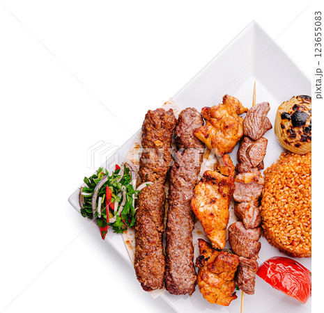 Grilled meat platter with rice and fresh vegetables for dinner Grilled meat platter with rice and fresh vegetables for dinner 123655083