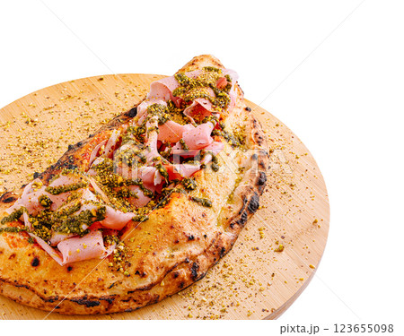 Savory flatbread topped with prosciutto and pistachio garnish Savory flatbread topped with prosciutto and pistachio garnish 123655098
