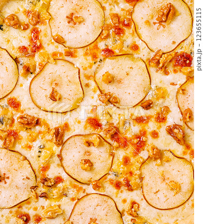 Delicious pizza topped with pear slices and walnuts Delicious pizza topped with pear slices and walnuts 123655115