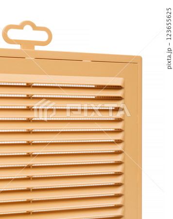 Ventilation grate isolated on a white background. Material plastic. Color orange. Close-up. 123655625