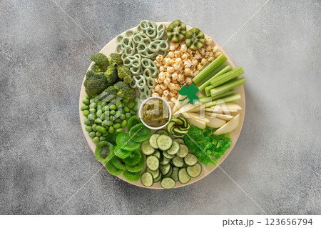 St Patricks day green fresh vegetable charcuterie board decorated shamrock isolated on transparent background. View from above. St Patricks day green fresh vegetable charcuterie board decorated shamrock isolated on transparent background. View from above. 123656794