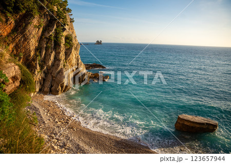 Coast landscape with rocks, sea, beach and vegetation near ancient fort in Petrovac, Montenegro in winter time. 123657944