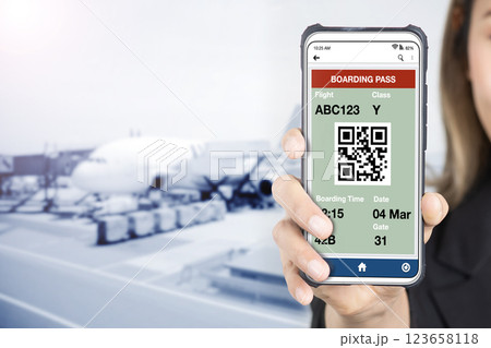 Businesswoman holding smartphone showing e-boarding on screen. Businesswoman holding smartphone showing e-boarding on screen. 123658118