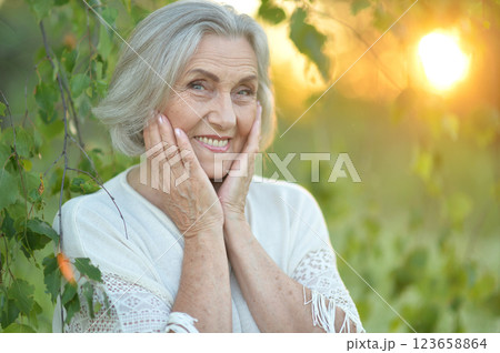 Portrait of a beautiful elderly woman in the park 123658864