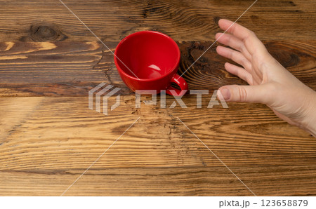 Hand Holds Cup, Empty Red Cup in Hands, Coffee Mug, Teacup, Hot Beverage Mockup 123658879