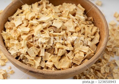 Dry parsley root, dried diced celery cubes, scattered small liquorice pileces, dry vegetable 123658943