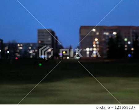 Blurred abstract background view of apartment buildings high-rise buildings at night. Colorful bokeh from view of apartment buildings high-rise buildings blurred in highway. Urban motion concept Blurred abstract background view of apartment buildings high-rise buildings at night. Colorful bokeh from view of apartment buildings high-rise buildings blurred in highway. Urban motion concept 123659237