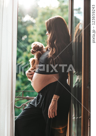 Beautiful pregnant woman at home in the doorway Beautiful pregnant woman at home in the doorway 123659243
